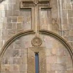 Send Cross and Wheel of Eternity carved out of the wall of Cathedral of St. John the Baptist